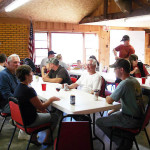 Group of people having a discussion around a table in a cozy room.