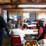 People gathered in a rustic room for a meeting or event.