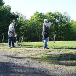 Two men playing golf on a sunny day.