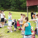 Group of people enjoying an outdoor gathering on a sunny day.
