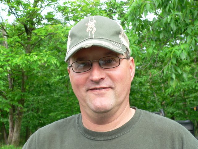A man wearing glasses and a hat.