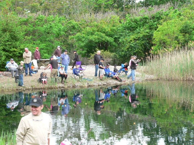 A group of people fishing in the water.