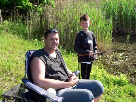 A man and boy sitting in lawn chairs
