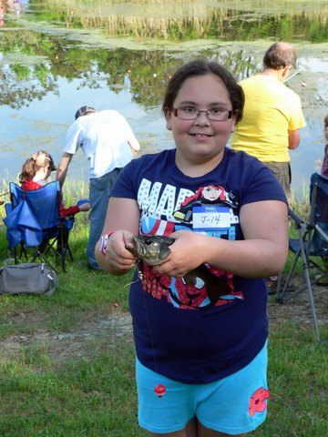 A girl holding a fish in her hands.