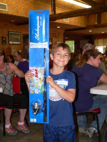 A boy holding up a blue box with a fish on it.