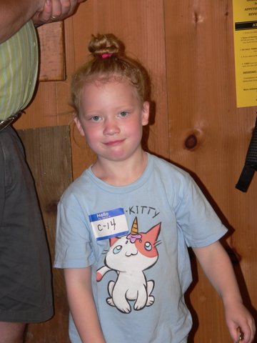 A young boy wearing a cat shirt and smiling.